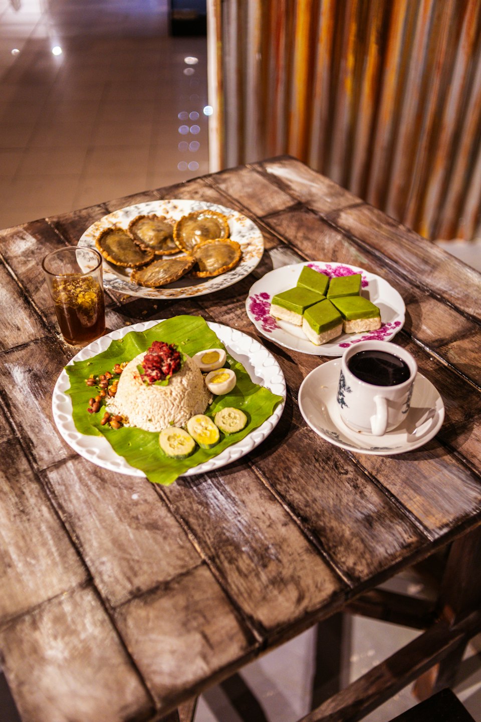Traditional Indonesian dishes arranged on a weathered wooden table.