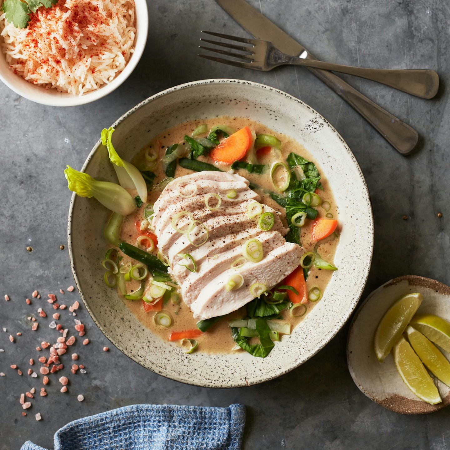 Overhead view of chicken and bok choy in a rustic bowl.